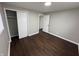 Bright bedroom featuring dark brown flooring and ample closet space at 1801 W Morris St, Indianapolis, IN 46221