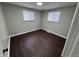 Roomy bedroom with dark brown laminate wood flooring and neutral walls at 1801 W Morris St, Indianapolis, IN 46221