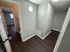 Clean hallway with dark brown vinyl flooring and access to bathroom at 1801 W Morris St, Indianapolis, IN 46221
