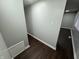 Hallway with dark brown vinyl flooring and access to bedroom at 1801 W Morris St, Indianapolis, IN 46221