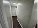 Long hallway with dark brown flooring and neutral-colored walls at 1801 W Morris St, Indianapolis, IN 46221