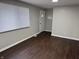 Living room with dark brown flooring, a window, and an entryway at 1801 W Morris St, Indianapolis, IN 46221