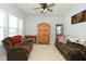 Living room featuring brown reclining sofas, wooden cabinet, and American flag art at 19243 Foley Dr, Westfield, IN 46074