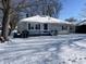 Front view of house with snowy lawn and porch at 2116 N Rosewood Ave, Muncie, IN 47304