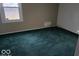 Empty bedroom with green carpet and window at 2435 N Eaton Ave, Indianapolis, IN 46219