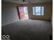 Spacious living room with neutral carpeting and a ceiling fan at 2435 N Eaton Ave, Indianapolis, IN 46219