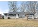 Newly renovated ranch home with gray and beige exterior and landscaped lawn at 2521 Cicero Rd, Noblesville, IN 46060