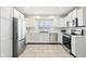 Updated kitchen with white cabinets, stainless steel appliances, and a farmhouse sink at 2521 Cicero Rd, Noblesville, IN 46060