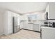 Modern kitchen with white cabinets, stainless steel appliances, and tiled floors at 2521 Cicero Rd, Noblesville, IN 46060