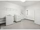 Bright laundry room with washer, dryer, and ample shelving at 2521 Cicero Rd, Noblesville, IN 46060
