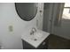Bathroom with vanity, sink, and round mirror at 3469 N Capitol Ave, Indianapolis, IN 46208
