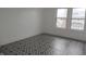 Well-lit bedroom featuring large windows and geometric tile floors at 3469 N Capitol Ave, Indianapolis, IN 46208