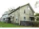 Two story house with green siding and a brick base at 3469 N Capitol Ave, Indianapolis, IN 46208