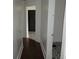 Long hallway with dark wood floors and access to other rooms at 3469 N Capitol Ave, Indianapolis, IN 46208