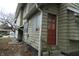 Side of house with red door and green siding at 3469 N Capitol Ave, Indianapolis, IN 46208