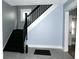 Staircase with black railing and gray walls at 3469 N Capitol Ave, Indianapolis, IN 46208