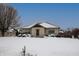 Snow covered home with stone exterior, wood accents, and a covered deck at 3660 W Smith Valley Rd, Greenwood, IN 46142