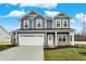 Two-story gray house with white trim and a three-car garage at 4070 Railhead Ave, Westfield, IN 46074