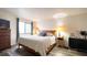 Comfortable bedroom with wood-look floors, a large window, and ample space for storage at 4351 Village Parkway W Cir # 5, Indianapolis, IN 46254