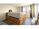 Bedroom with wood platform bed and large window at 4351 Village Parkway W Cir # 5, Indianapolis, IN 46254