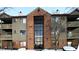 Brick and siding condo building with snow-covered landscaping at 4351 Village Parkway W Cir # 5, Indianapolis, IN 46254