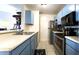 Kitchen featuring stainless steel appliances, light countertops, and blue cabinets with modern hardware at 4351 Village Parkway W Cir # 5, Indianapolis, IN 46254