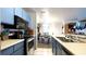 Updated kitchen with stainless steel appliances and blue cabinets, looking out to dining and living areas at 4351 Village Parkway W Cir # 5, Indianapolis, IN 46254