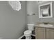 Clean bathroom with light vanity, toilet and window at 4652 Kimmeridge Ln, Indianapolis, IN 46254