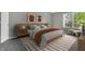 Bright bedroom with wooden bed frame and striped rug at 4652 Kimmeridge Ln, Indianapolis, IN 46254