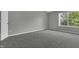 Bright bedroom with gray carpet and large window at 4652 Kimmeridge Ln, Indianapolis, IN 46254