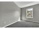 Well-lit bedroom with a large window and grey carpet at 4652 Kimmeridge Ln, Indianapolis, IN 46254