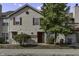 Tan two-story townhouse with red door and landscaping at 4652 Kimmeridge Ln, Indianapolis, IN 46254