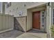 Red door entry to tan townhouse with brick accents at 4652 Kimmeridge Ln, Indianapolis, IN 46254