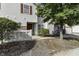 Tan two-story townhouse with red door and landscaping at 4652 Kimmeridge Ln, Indianapolis, IN 46254