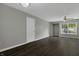 Spacious living room featuring dark hardwood floors and large windows at 4652 Kimmeridge Ln, Indianapolis, IN 46254