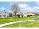 Spacious backyard with lush lawn, mature tree, a golf cart and a path leading towards the house at 4842 Ashbrook Dr, Noblesville, IN 46062