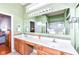 Well-lit bathroom featuring a long vanity with double sinks and a large mirrored wall at 4842 Ashbrook Dr, Noblesville, IN 46062