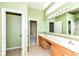 Bright bathroom featuring double vanity with generous counter space, tile flooring and fresh green paint at 4842 Ashbrook Dr, Noblesville, IN 46062