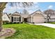 Single-story home with great curb appeal, lush lawn, and a two-car garage at 4842 Ashbrook Dr, Noblesville, IN 46062