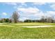 Golf course featuring a sand trap, blue flag and lush green grass under a beautiful sky at 4842 Ashbrook Dr, Noblesville, IN 46062