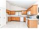 Bright kitchen with ample oak cabinets, white appliances, and modern track lighting for a functional cooking space at 4842 Ashbrook Dr, Noblesville, IN 46062