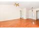 Bright living room with hardwood floors, ceiling fan, and natural light streaming through a front door and sidelights at 4842 Ashbrook Dr, Noblesville, IN 46062