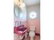 Pink tiled half bathroom with a vintage sink and toilet at 502 W 38Th St, Indianapolis, IN 46208