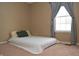 Bright bedroom with window and neutral walls at 504 Grand Woods Dr, Indianapolis, IN 46224