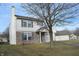 Two-story house with vinyl siding, brick accents, and attached garage at 504 Grand Woods Dr, Indianapolis, IN 46224