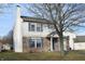 Two-story house with vinyl siding, brick accents, attached garage, and landscaping at 504 Grand Woods Dr, Indianapolis, IN 46224