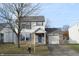 Two-story house with vinyl siding, brick skirt, attached garage, and front yard at 504 Grand Woods Dr, Indianapolis, IN 46224
