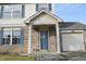 Two-story house with brick front, covered entryway, and a blue door at 504 Grand Woods Dr, Indianapolis, IN 46224