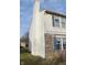 Vinyl sided exterior wall with brick base and a tall chimney at 504 Grand Woods Dr, Indianapolis, IN 46224