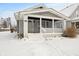 Gray bungalow with a covered porch and snowy front yard at 5116 E St Clair E St, Indianapolis, IN 46219